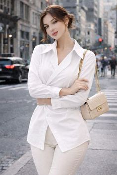 Woman in a white shirt and light pants on a city street