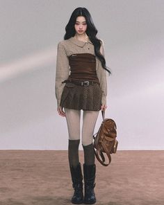 Woman with long black hair wearing a plaid shirt, corset top, and pleated skirt