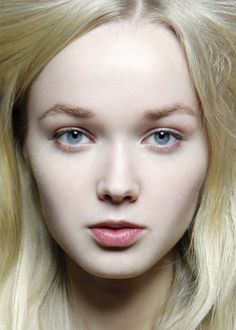 Close up portrait of a woman with blonde hair and blue eyes