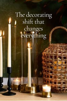 Taper candles in various holders and a wicker lantern providing warm lighting