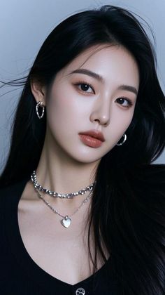 Woman with long black hair and silver jewelry in a close-up portrait