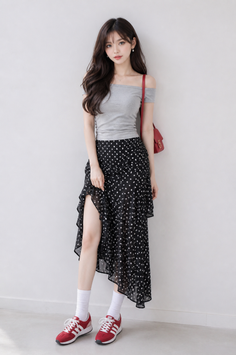Woman in an off-shoulder top and polka dot skirt with red sneakers