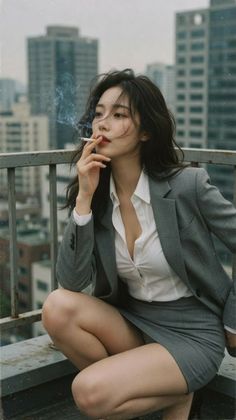 Woman in a suit jacket and mini skirt smoking on a rooftop