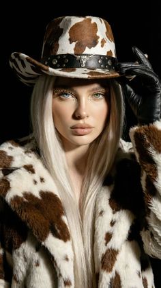 Woman with blonde hair and heterochromia wearing a cowboy hat and faux fur coat