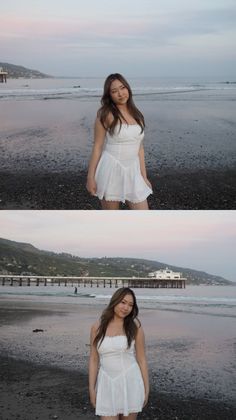 Woman in a white dress standing on a beach with a pier in the background