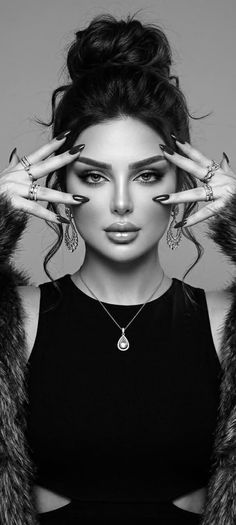 Woman with an updo hairstyle and jewelry, wearing a fur coat in black and white