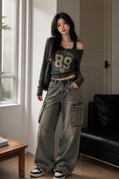 Woman with long dark hair wearing cargo pants and an off-shoulder top indoors