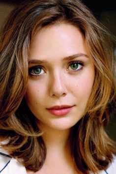 Close up portrait of a woman with green eyes and brown hair