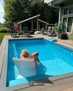 Person relaxing in a lounge chair in a swimming pool on a sunny day