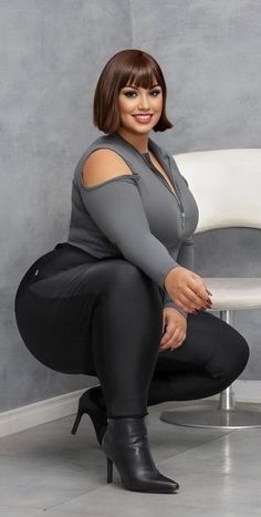 Woman with short hair and a curvy body in black leggings and high heels