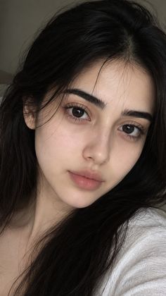 Close up portrait of a woman with long dark hair and natural makeup