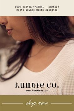 Woman with long dark hair wearing a white shirt and necklace