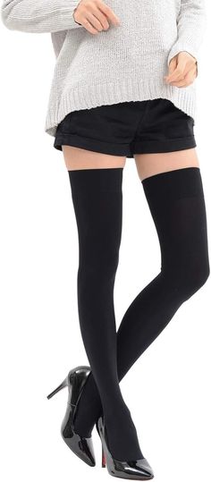 Person in black shorts, thigh-high socks, and a gray sweater with high heels
