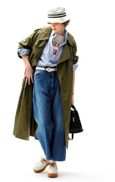 Person in a bucket hat, trench coat, and baggy jeans with a white background