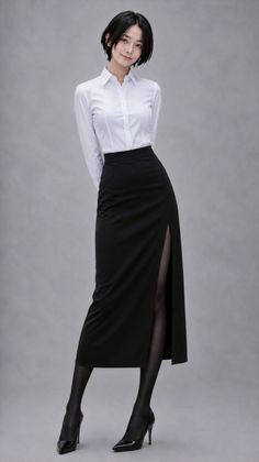 Woman in a white shirt and black skirt with a slit, posing in a studio