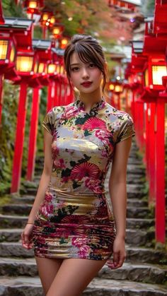 Woman in a floral cheongsam dress on a stone staircase with red lanterns