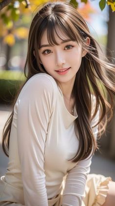 Woman with long brown hair and a long sleeve shirt outdoors