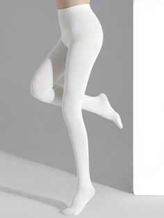 Person wearing white tights in a studio setting