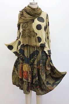 Boho style outfit on a mannequin with a polka dot top and butterfly print skirt