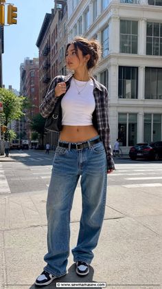 Woman in a plaid shirt and baggy jeans on a city street