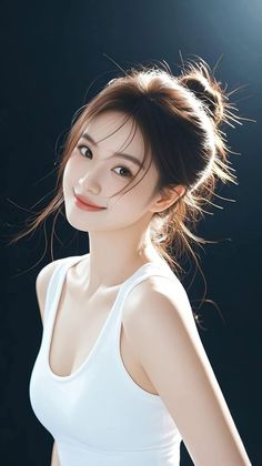 Woman in a white tank top with a messy bun and backlight on a dark background