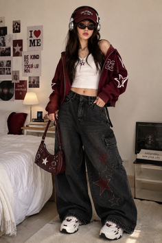 Woman in a crop top, baggy jeans, and hoodie with a baseball cap and headphones