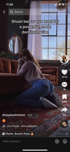 Woman in jeans and a t-shirt kneeling on a rug indoors