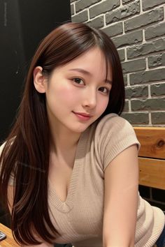 Woman with long brown hair wearing a v-neck top indoors