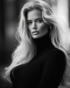 Woman with long blonde hair wearing a black turtleneck in a monochrome portrait