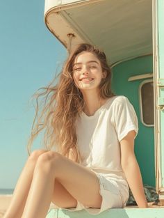 Young woman with long hair smiling with closed eyes on a sunny beach