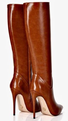 Pair of brown leather knee-high boots with high heels