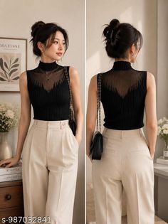 Woman in a black sheer top and beige pants posing indoors