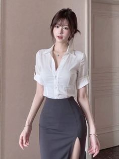 Woman in a white shirt and a dark pencil skirt with a high slit