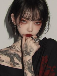 Woman with short black hair and dragon tattoos wearing an off-shoulder top