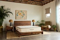 Bedroom with a wooden bed frame, Avocado mattress, and indoor plants