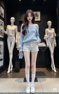 Woman in an off-shoulder sweater and white shorts standing in a storefront