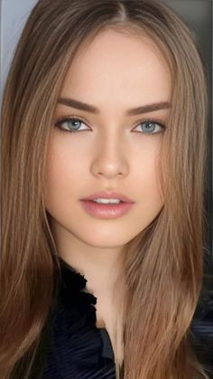 Close up portrait of a young woman with long blonde hair and blue eyes