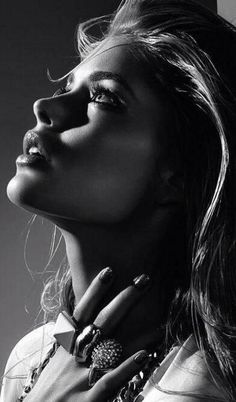 Black and white portrait of a woman with dramatic lighting and jewelry