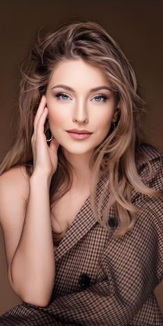 Woman with long blonde hair and blue eyes wearing a plaid shirt