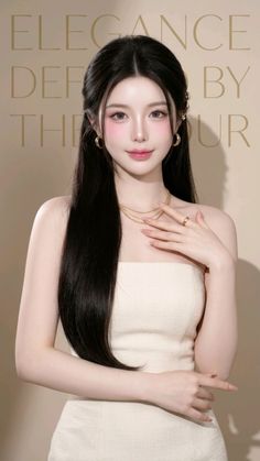 Woman with long dark hair wearing a strapless dress and gold jewelry
