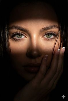 Close up portrait of a woman with green eyes and dramatic lighting