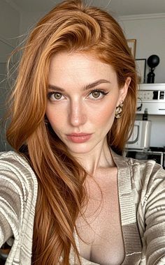 Woman with red hair and freckles wearing a striped top, showing cleavage