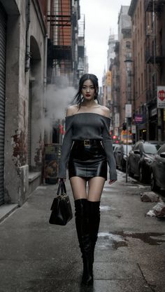 Woman in an off-shoulder top and leather skirt walking on a wet city street