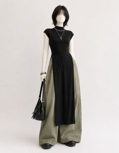 Mannequin wearing a black top with wide leg pants and a cross necklace