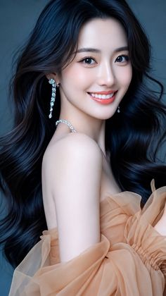 Woman with long black hair wearing a strapless dress and jewelry, smiling