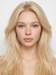 Young woman with long blonde hair and blue eyes looking directly at the camera