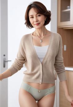 Woman in a cardigan and underwear posing indoors