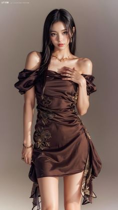 Woman in a brown off-shoulder dress with gold embroidery and jewelry
