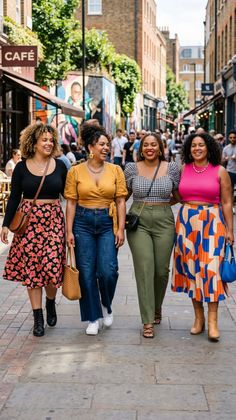 Four women walking and laughing on a busy street during the day