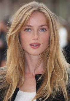 Woman with blonde hair and blue eyes, showing freckles on her face